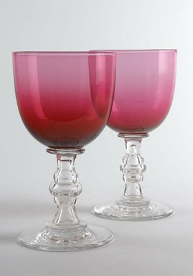 Lot 81 - A large pair of early 19th century cranberry glass wine goblets