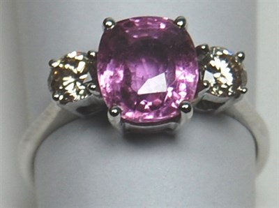 Lot 163 - A modern lilac sapphire and diamond three-stone ring