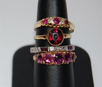 Lot 32 - An 18ct white gold mounted ruby and diamond full-eternity ring