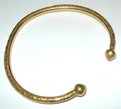 Lot 34 - An Eastern gold torque form bangle
