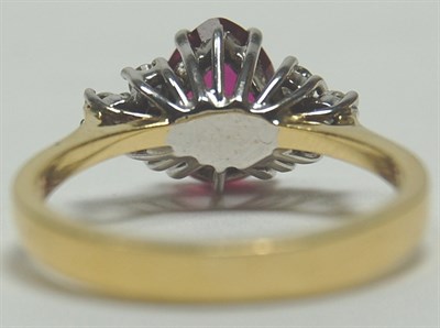 Lot 144 - A modern 18ct gold mounted ruby and diamond cluster ring