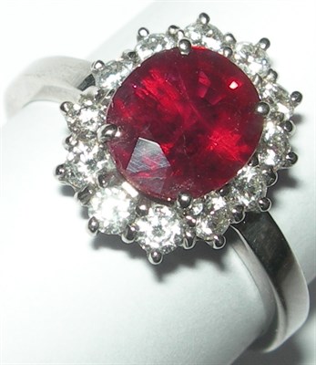 Lot 140 - An 18ct white gold mounted ruby and diamond cluster ring