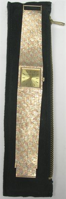 Lot 11 - BUECHE-GIROD - a gentleman's tri-colour 9ct gold wrist watch
