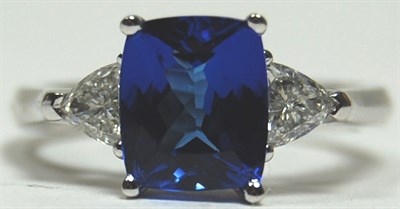 Lot 166 - A contemporary Tanzanite and diamond three-stone ring
