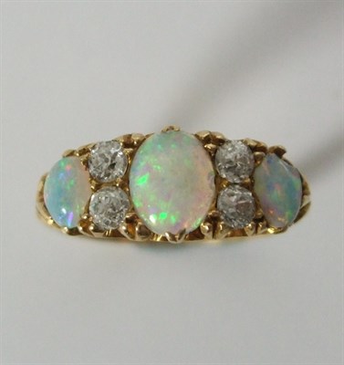 Lot 1 - A diamond and opal cluster ring