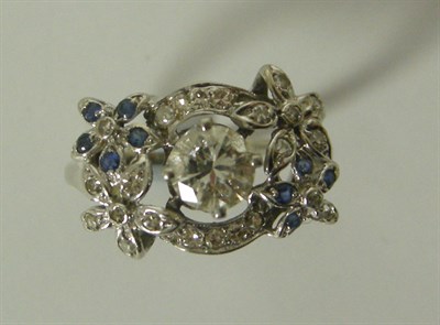 Lot 59 - A diamond and sapphire floral ring