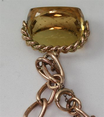 Lot 39 - A 9ct rose gold bracelet suspending three large swivel fobs