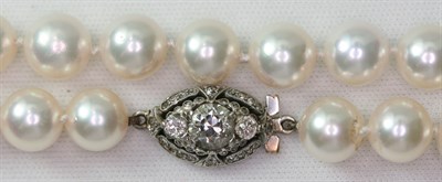 Lot 144 - A CULTURED pearl necklace with diamond set clasp