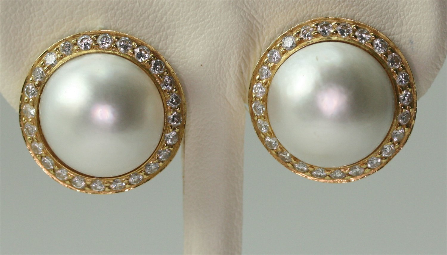 Lot 140 - THEO FENNELL - a pair of 18ct gold mounted mabe pearl and diamond set earrings