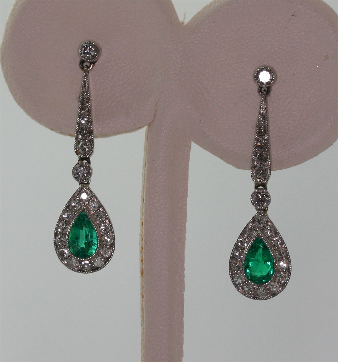 Lot 104 - A pair of emerald and diamond set pendant earrings