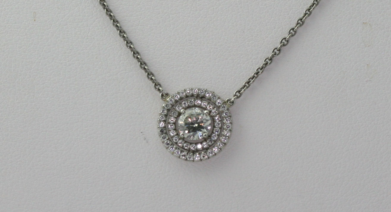 Lot 52 - A diamond cluster pendant with chain