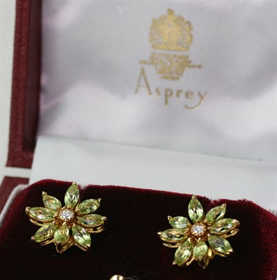 Lot 208 - ASPREY - a pair of contemporary 18ct gold mounted diamond and peridot set earrings