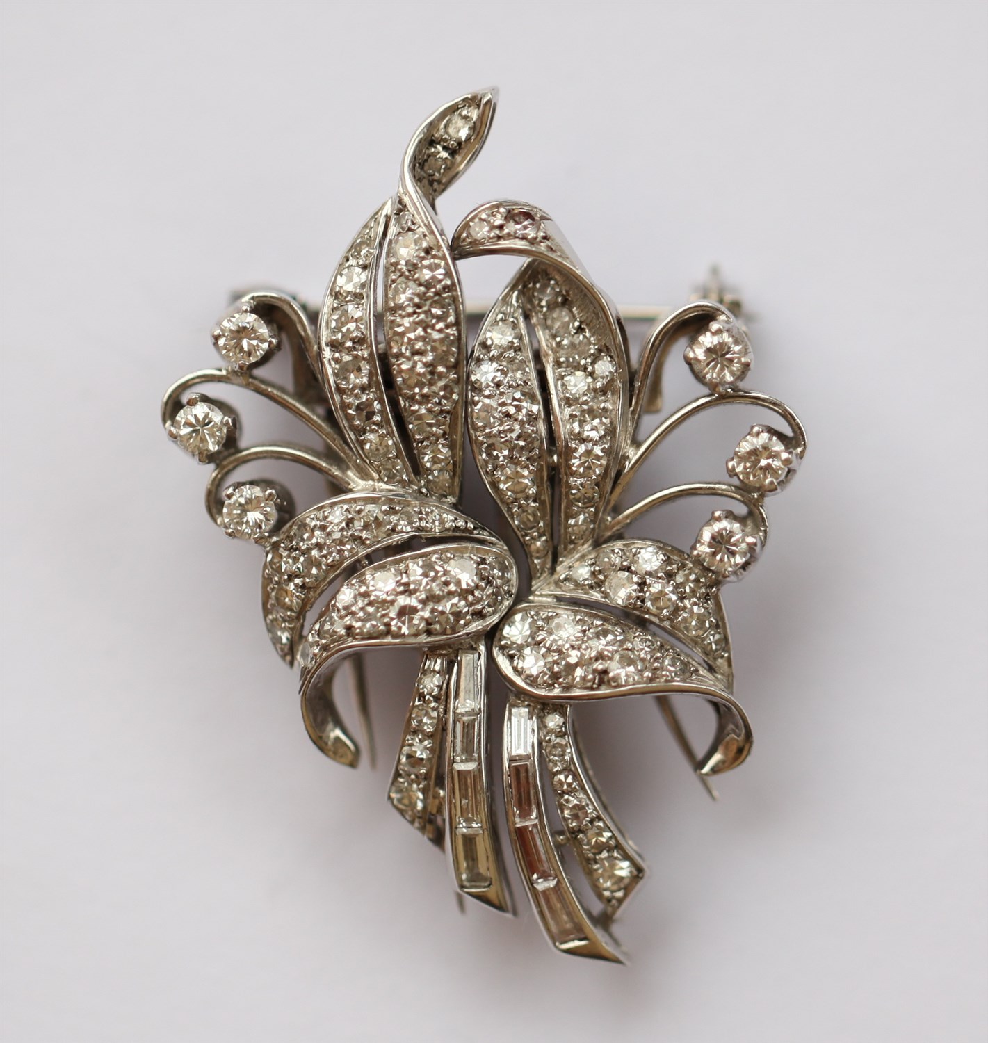 Lot 170 - An early 20th century diamond set pair of clips/brooch