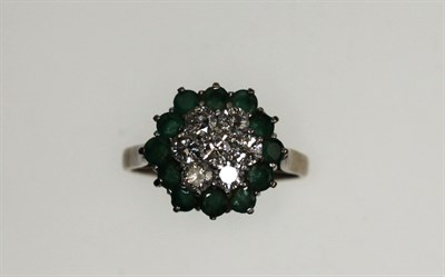 Lot 231 - A diamond and emerald ring