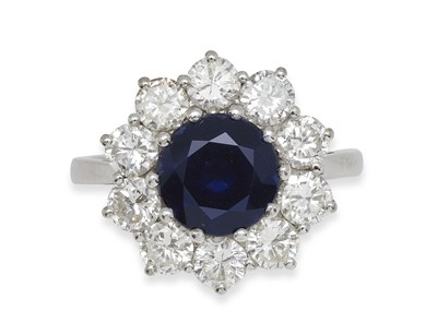 Lot 307 - An 18ct white gold mounted sapphire and diamond cluster ring