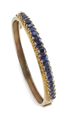 Lot 334 - An Edwardian sapphire and diamond set bangle