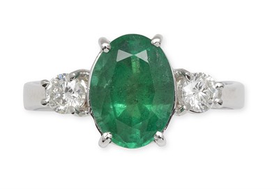 Lot 237 - An 18ct white gold mounted emerald and diamond three-stone ring