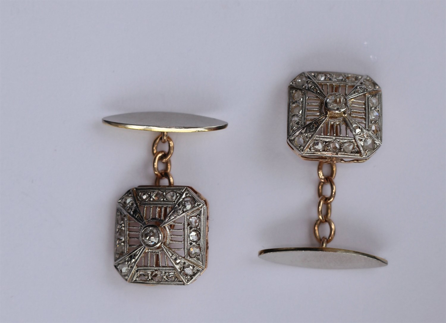 Lot 114 - A pair of early 20th century diamond set cufflinks