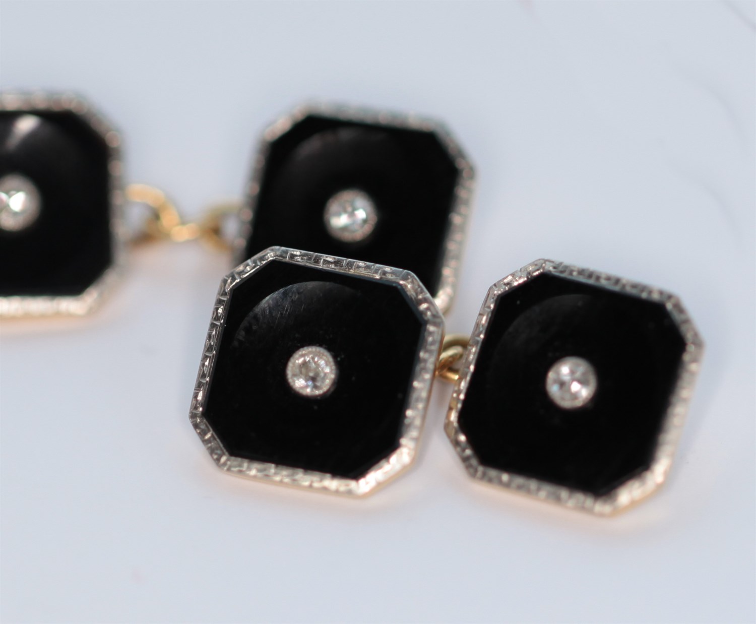 Lot 106 - An early 20th century pair of 18ct gold and platinum mounted onyx and diamond set cufflinks