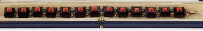 Lot 399 - STYLE OF BOUCHERON - An Art Deco period onyx, coral and gold bracelet