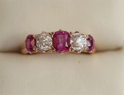 Lot 325 - A five stone ruby and diamond set ring