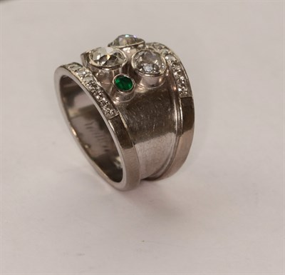 Lot 279 - An 18ct white gold abstract diamond and emerald ring