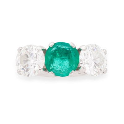 Lot 281 - A platinum mounted emerald and diamond set three-stone ring