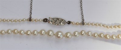 Lot 315 - An early 20th century natural pearl necklace with diamond set clasp