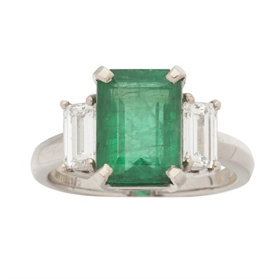 Lot 20 - A Columbian emerald and diamond set three-stone ring
