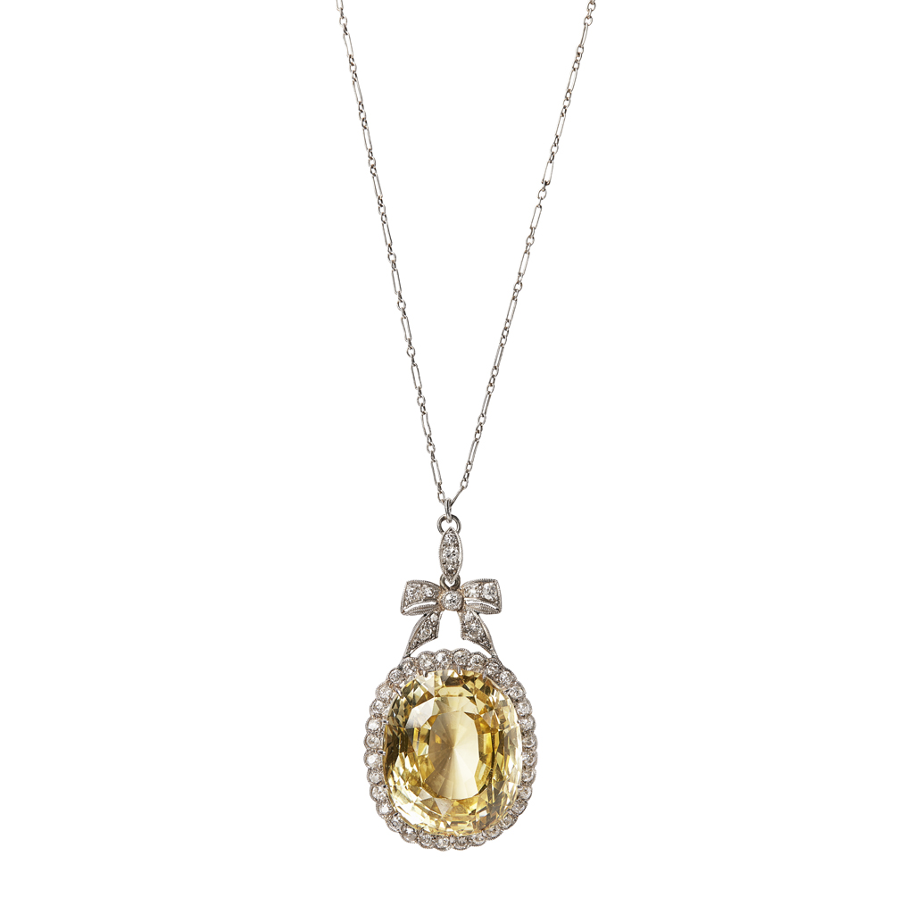 Lot 93 - A yellow sapphire and diamond set cluster pendant
