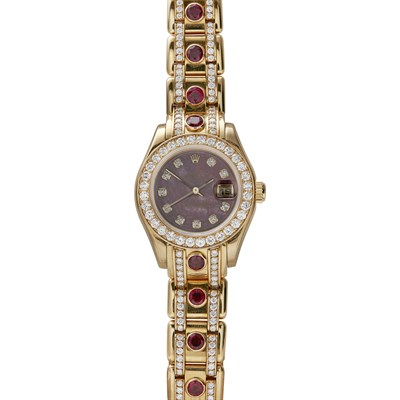 Lot 71 - ROLEX - An 18ct gold ruby and diamond set lady's wrist watch