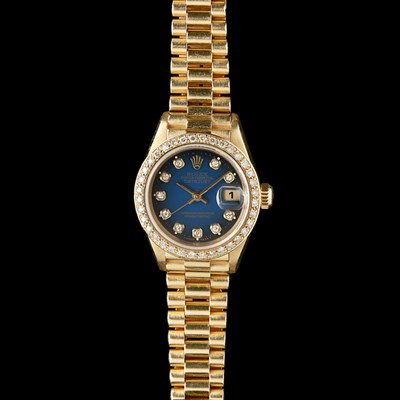 Lot 73 - ROLEX - A lady's 18ct gold and diamond set wrist watch