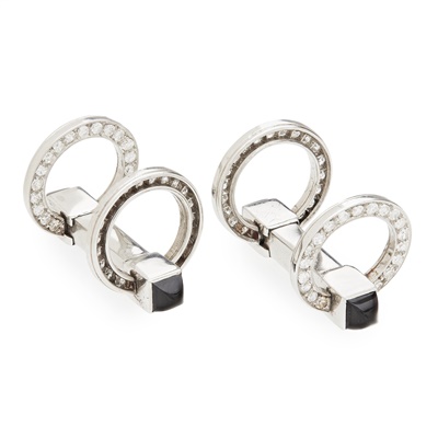 Lot 142 - A pair of diamond and onyx set cufflinks