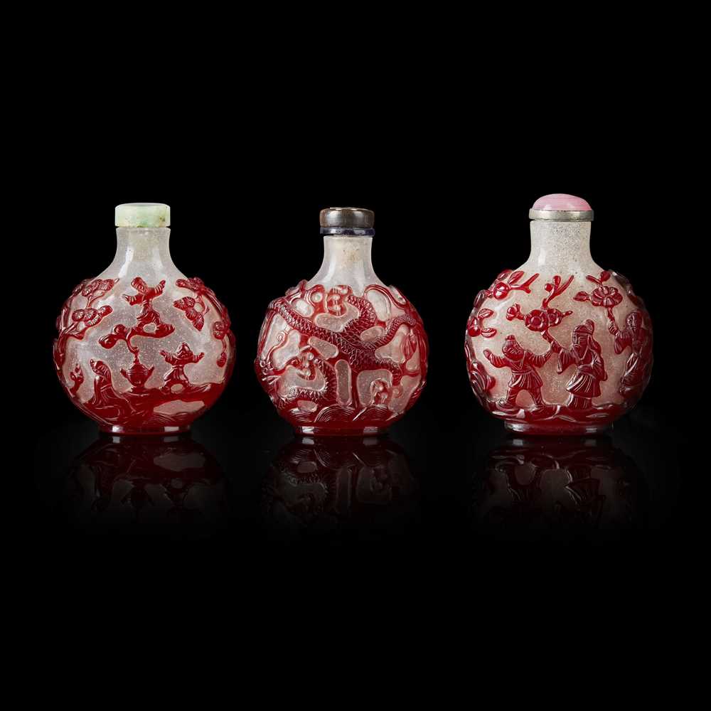 Lot 81 - GROUP OF THREE RED OVERLAY PEKING GLASS SNUFF BOTTLES