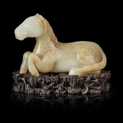 Lot 134 - PALE CELADON AND RUSSET JADE CARVING OF A HORSE