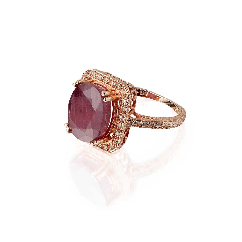 Lot 105 - A ruby and diamond set cluster ring
