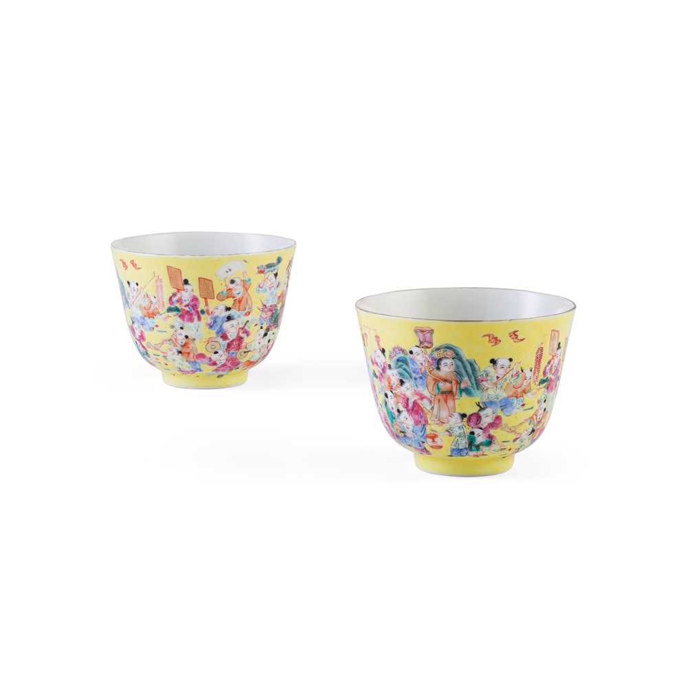 Lot 232 - PAIR OF FAMILLE ROSE YELLOW-GROUND 'BOYS AT PLAY' CUPS
