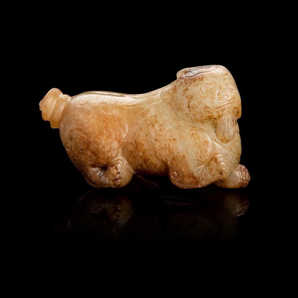 Lot 93 - PALE CELADON AND RUSSET JADE CARVING OF A MYTHICAL ANIMAL