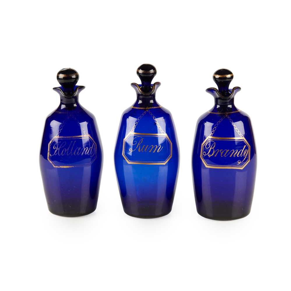 Lot 94 - A SET OF THREE BRISTOL BLUE GLASS DECANTERS AND STOPPERS