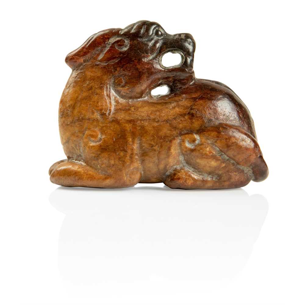Lot 85 - RUSSET JADE CARVING OF A MYTHICAL ANIMAL