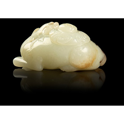 Lot 119 - PALE CELADON WITH RUSSET SKIN JADE CARVING OF A MYTHICAL CREATURE WITH 'BAGUA'