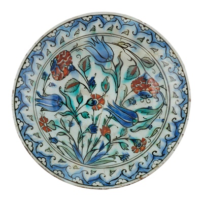 Lot 298 - AN IZNIK POTTERY DISH WITH TULIPS, CARNATIONS AND ROSES