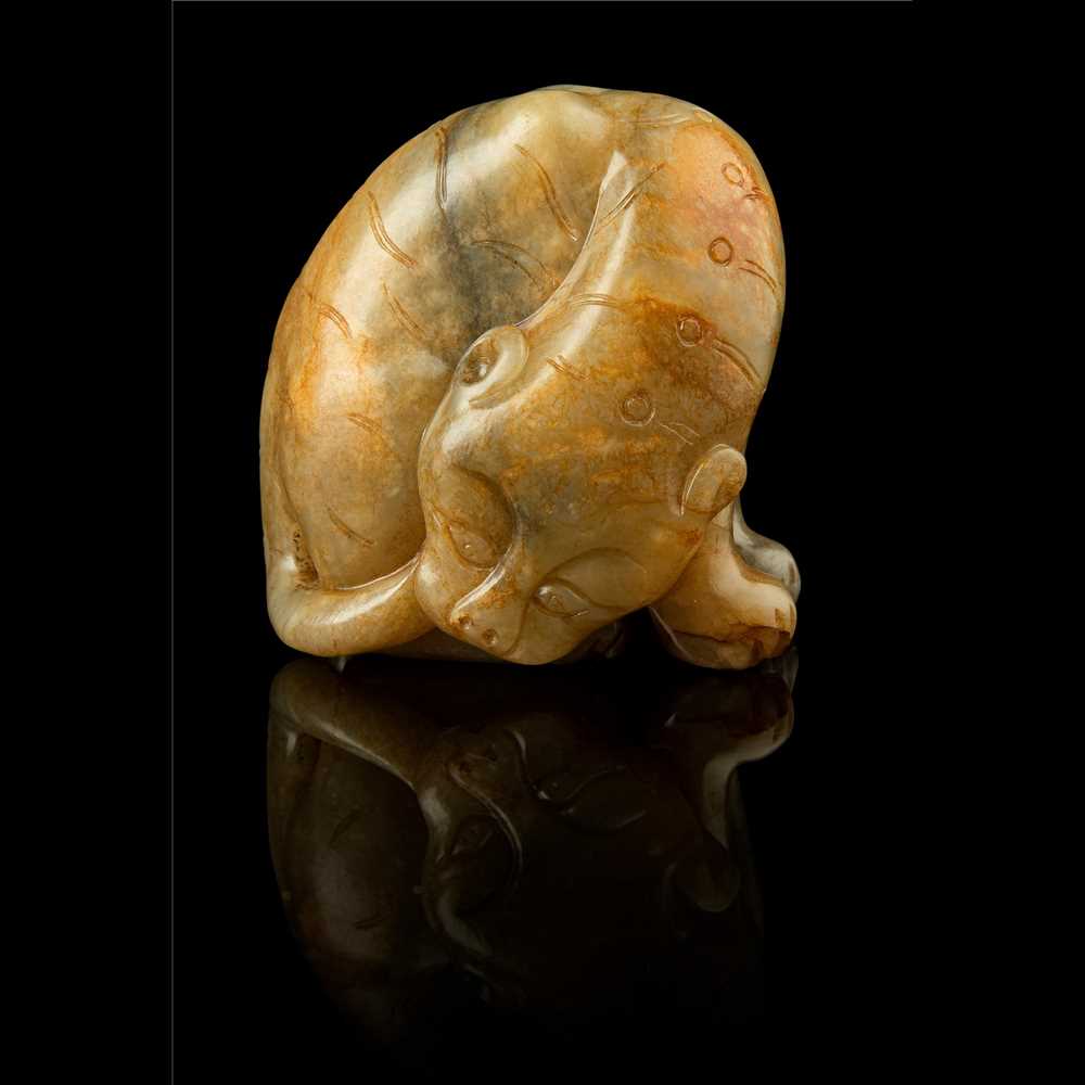 Lot 117 - CELADON JADE WITH RUSSET SKIN CARVING OF A TIGER