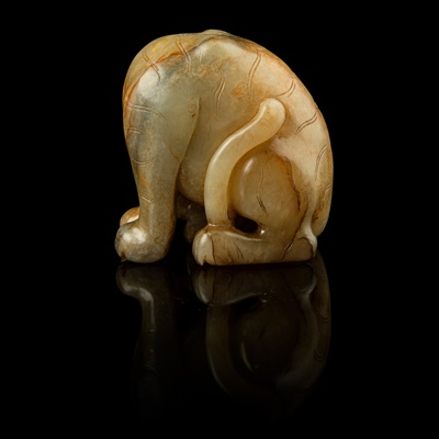 Lot 117 - CELADON JADE WITH RUSSET SKIN CARVING OF A TIGER
