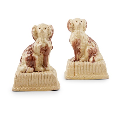 Lot 49 - A PAIR OF SCOTTISH GLAZED POTTERY SPANIELS