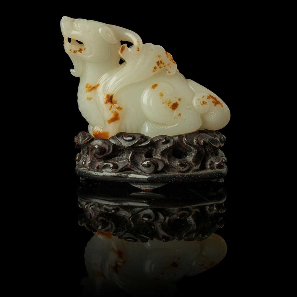 Lot 118 - WHITE JADE WITH RUSSET SKIN CARVING OF A MYTHICAL WINGED ANIMAL