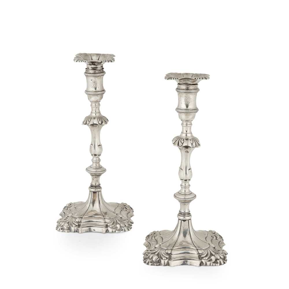 Lot 108 - A pair of George III cast table candlesticks