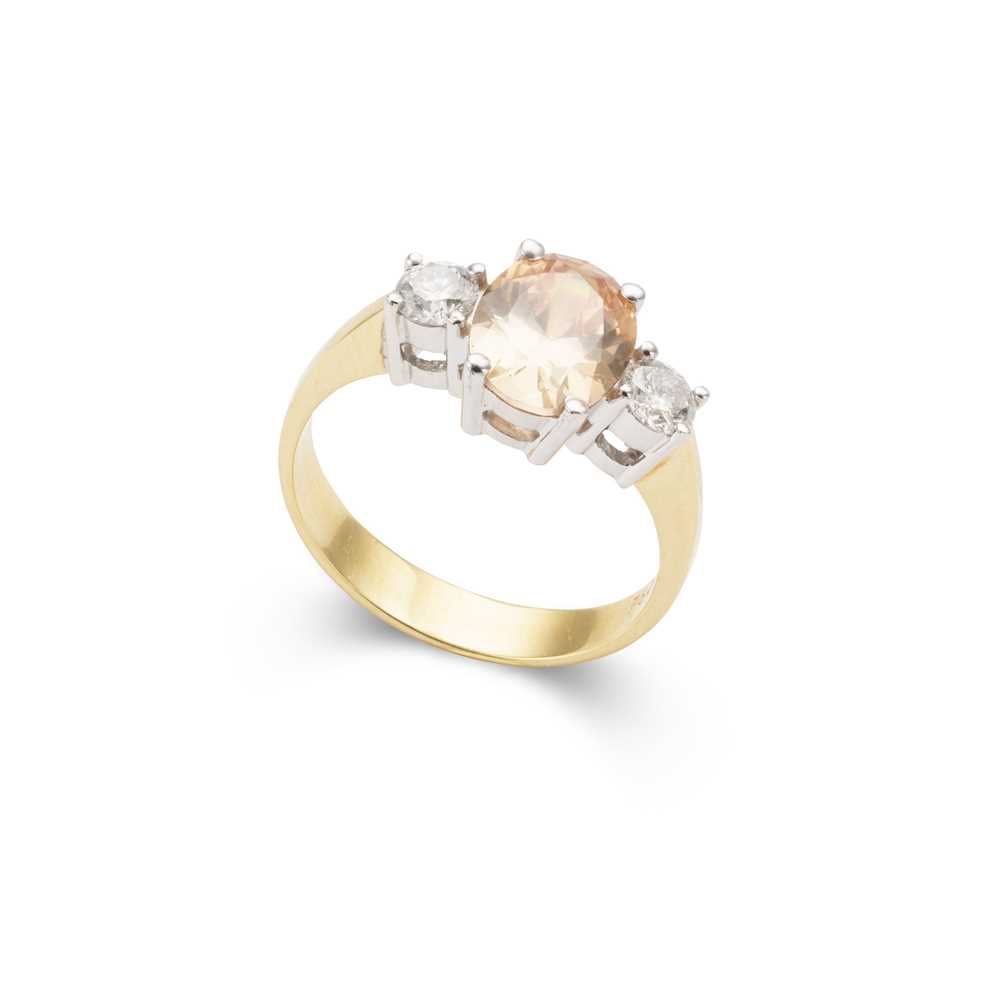 Lot 81 - An orange tourmaline and diamond three-stone ring