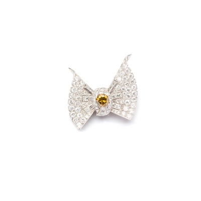 Lot 89 - Cartier: A diamond and coloured diamond bow brooch