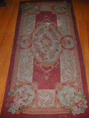 Lot 171 - An Aubusson tapestry panel, the burgundy field...